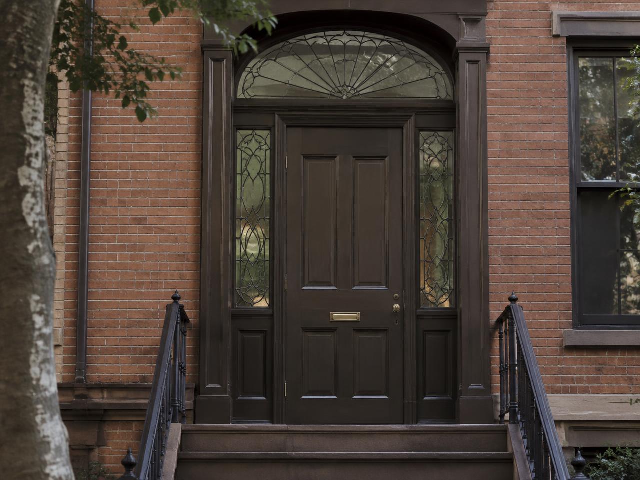 Panelled entry door with leaded fanlight and sidelights
